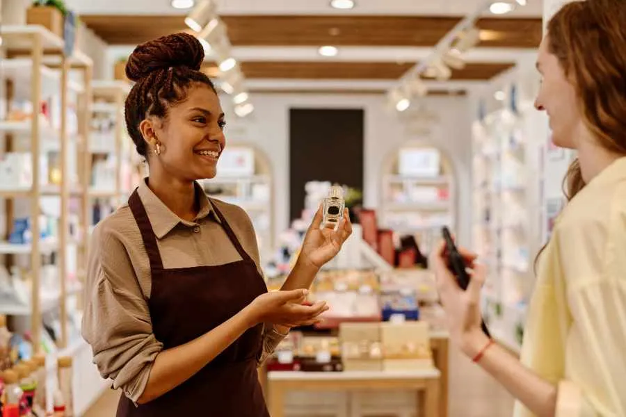 storeclerk selling cosmetics to customer in store